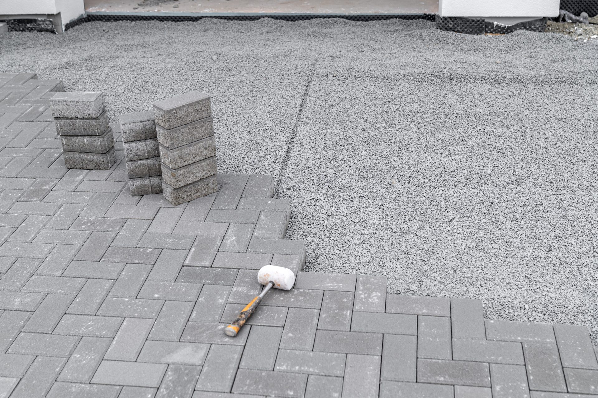 Verlegung von grauem Verbundpflaster auf tragfähigem Unterbau